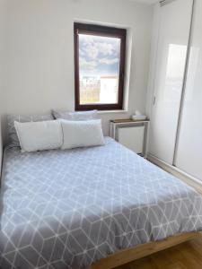 a bedroom with a large bed with a window at No̱410 City View Apartment & free parking in Krakow