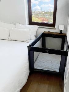 a bedroom with a bed with a mirror and a window at No̱410 City View Apartment & free parking in Krakow