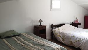 Letto o letti in una camera di Le Gîte du Lac d'Hostens