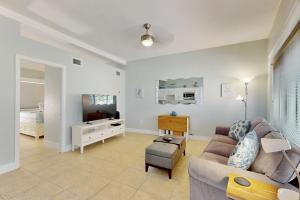 a living room with a couch and a bedroom at 53 Steps to Beach in Clearwater Beach