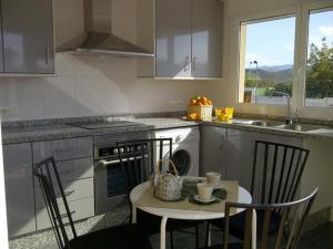 a kitchen with a table and chairs and a sink at Rainbow Home Coll Verd in Playa de Gandia