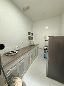أجنحة هومينج ــ Homing Suites的厨房或小厨房