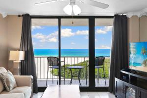 a living room with a view of the ocean at South Seas Tower 3 - Resort Pool - Gulf View in Marco Island