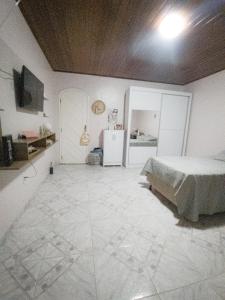 a bedroom with a bed and a tiled floor at Casa para COP30 no Centro de Belém in Belém