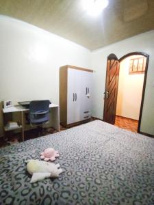 a bedroom with a bed with a desk and a door at Casa para COP30 no Centro de Belém in Belém