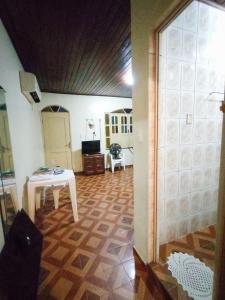 a living room with a table and a room with a table at Casa para COP30 no Centro de Belém in Belém