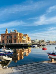 a city with buildings and boats in the water at Riccardo Luxury Apartment in Bari