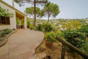 a walkway leading to a house with trees at Villa in Tossa de Mar (Santa María de Llorell) in Tossa de Mar