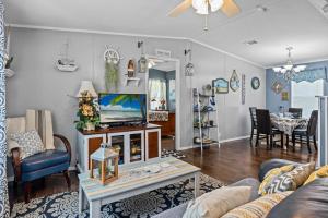 a living room with a couch and a tv at Palm Key Oasis - Close to Attractions in Davenport