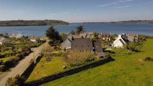 an aerial view of a town with a river and houses at Maison spacieuse et lumineuse à seulement 1 minute de la mer in Rosnoën