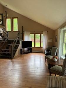 a large living room with a couch and a tv at Quiet Cozy Stay Spacious Home Near Beach & Shops in Hamden