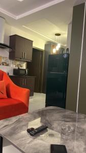 a living room with a red couch and a glass table at Apartment in Bahria Town Grand heights 8 Lahore in Lahore +5 photos