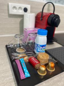 a tray with some food and a bottle of milk at Magnifique appartement in Tourcoing