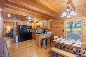 a kitchen and dining room in a log cabin at Smokies Outlook by Avada Properties in Pigeon Forge
