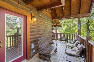 a porch of a cabin with rocking chairs on it at Smokies Outlook by Avada Properties in Pigeon Forge