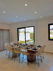 a large dining room with a table and chairs at Villa Elysia in Ech Chaïbat