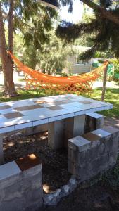 a picnic table with an orange hammock in a park at tu lugar para descansar in Valle Hermoso +15 photos