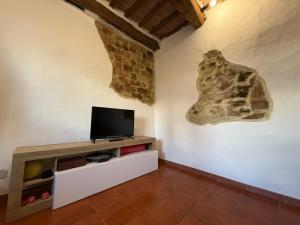 a living room with a flat screen tv on a wall at Casa Nerina in Chiusdino