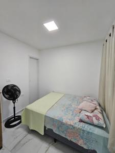 a white room with a bed and a window at Home Duplex Serra Negra - casa 8 in Bezerros