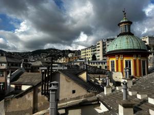 a building with a dome on top of a city at Genova Antica in Genoa