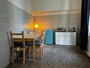 a kitchen with a table and chairs and a refrigerator at Genova Antica in Genoa