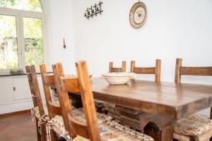 a dining room table with chairs and a bowl on it at Casa Le Anfore in Anacapri