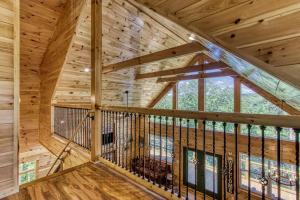 an attic room with a large window in a log cabin at Smokey Peak Inn by Avada Properties in Sevierville
