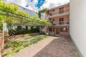 an exterior view of a building with a courtyard at Cvita in Baška Voda