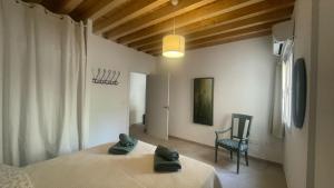 Un dormitorio con dos camas y una silla dentro. en Apartamentos Albahaca Albaycin, en Granada