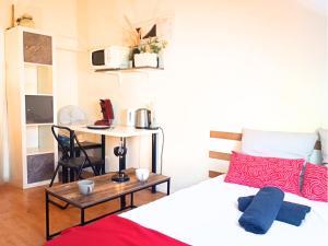 a bedroom with a bed and a desk with a table at Studio zen JD54#1 in Reims