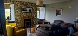 a living room with a couch and a fireplace at Orkney,Shapinsay in Kirkwall