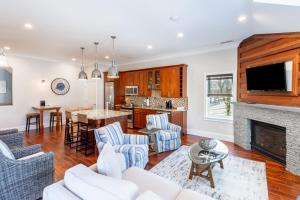 a living room with white furniture and a fireplace at The Newport Lofts - 548 Thames Street in Newport