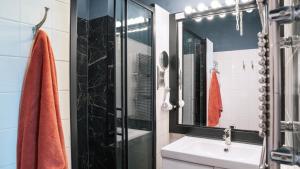 a bathroom with a sink and a shower at Authentic Amsterdam Apartment RAI in Amsterdam +28 photos