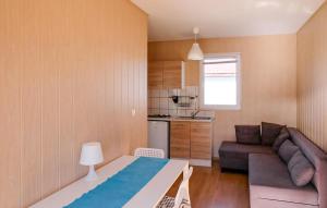 a small living room with a couch and a kitchen at Beautiful Home In Sarbinowo in Sarbinowo
