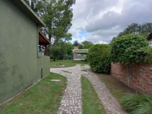 a stone walkway next to a brick wall at tu lugar para descansar in Valle Hermoso