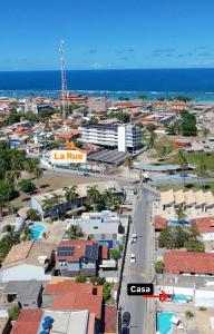 an aerial view of a city with the ocean at Casa na Praia do Frances in Marechal Deodoro