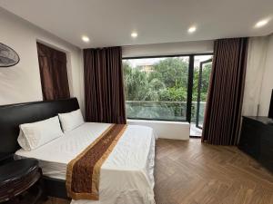 En eller flere senge i et værelse på Ngọc Trai 76 FLC Sầm Sơn