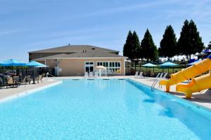 a large swimming pool with a water slide at Smith Mountain Lake Retreat with Resort Amenities! in Huddleston