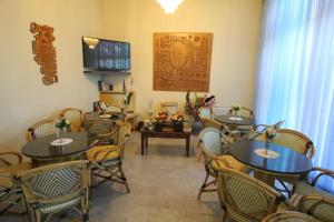 a dining room with tables and chairs and a television at Hotel Liliana Andora citr 9006-0004 in Marina di Andora