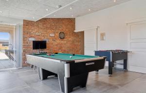 a living room with a pool table and a tv at Nice Home In Thisted With Sauna in Thisted