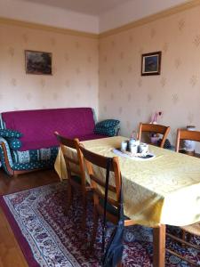 a living room with a table and a couch at Villa Belles Rives in Bellerive-sur-Allier