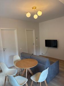 a living room with a couch and a table and chairs at Vivic apartment Monforte in Monforte dʼAlba