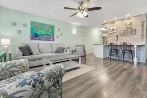 a living room with a couch and a table at Sandy Paws in Navarre