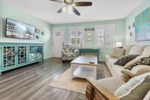 a living room with a couch and a table at Sandy Paws in Navarre