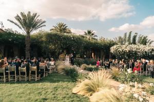 a group of people sitting in chairs at a wedding ceremony at The Source Hotel Music & Spa in Marrakesh +37 photos