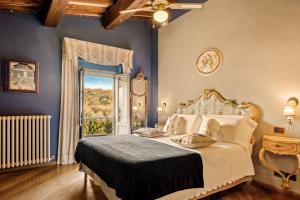 a bedroom with a bed and an open window at I Capricci Di Merion - Resort & Spa in Tuoro sul Trasimeno +57 photos