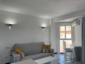 a living room with a couch and a table at Terrasol Estudios Plazamar in Torre del Mar
