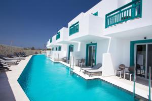 a swimming pool in front of a villa at Mastichari Bay Hotel in Mastihari