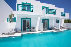 a villa with a pool in front of it at Mastichari Bay Hotel in Mastihari