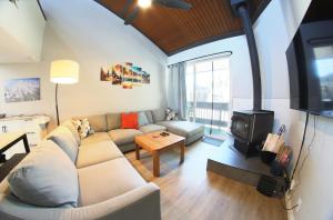 a living room with a couch and a stove at Mammoth Getaway - Chic Condo in Mammoth Lakes